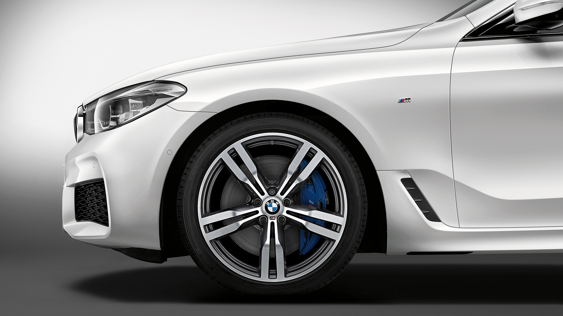BMW 6-sarjan Gran Turismo G32, M Sport -paketti, perä, keula sivulta BMW 6-sarjan Gran Turismo G32 2017, M Sport -paketti, metalliväri Mineral White, keula sivulta ja kevytmetallivanteet Double-spoke 647 M