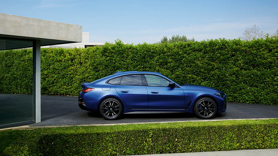 Näkymä perästä BMW i4 M50 G26 2021 ajamassa maantiellä BMW i4 M50 G26 2021 BMW Individual -metalliväri Frozen Portimao Blue, näkymä perästä, ajamassa maantiellä