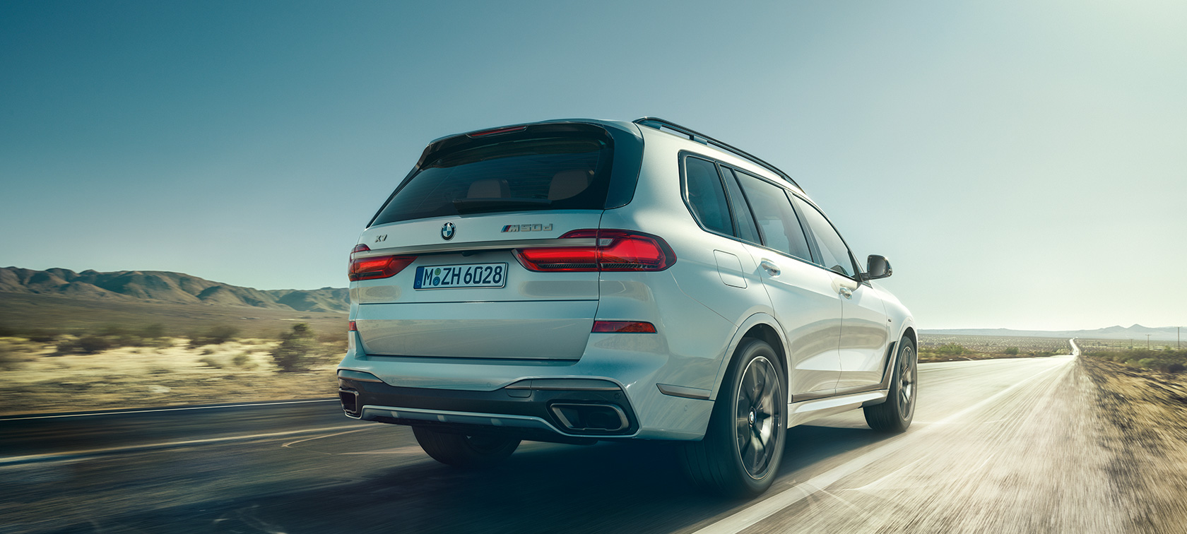 BMW X7 M50d, näkymä takaa BMW X7 M50d Mineral White, ajaa yksinäisellä moottoritiellä, näkymä takaa, G07, 2019