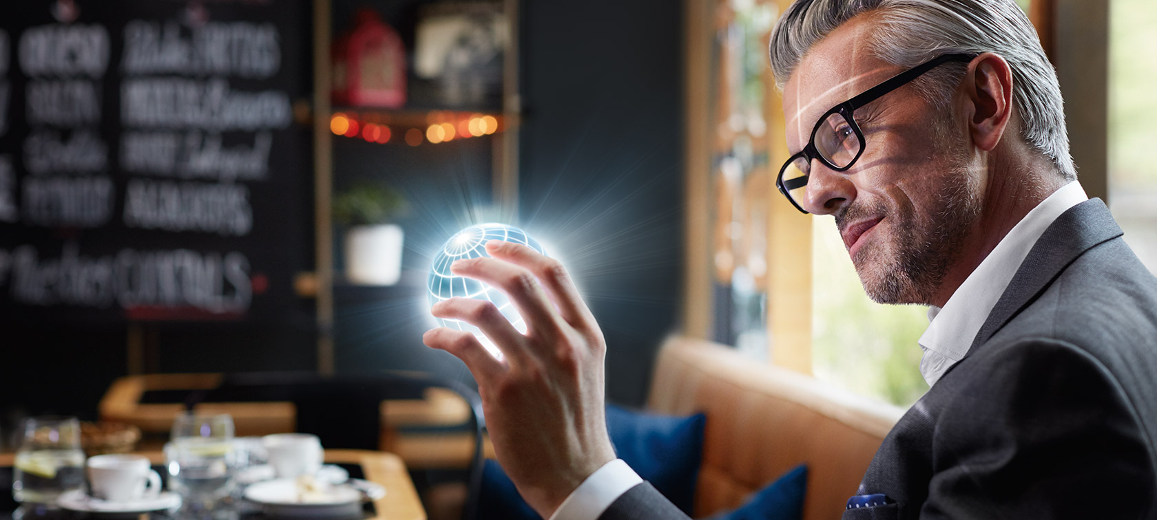 BMW ConnectedDrive digitaaliset palvelut Mies pitää ConnectedDrive-maapalloa kädessään ja on lumoutunut.